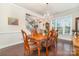 Elegant dining room with a hardwood table, chandelier, and bright window at 9807 Maywine Cir, Huntersville, NC 28078