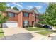 Classic brick home with an attached garage, neat landscaping, and a welcoming facade at 9807 Maywine Cir, Huntersville, NC 28078