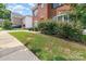 Well-manicured front yard with lush green grass and mature bushes, showcasing the home's curb appeal at 9807 Maywine Cir, Huntersville, NC 28078