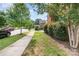 Inviting front yard with a sidewalk and green lawn, adjacent to a tree-lined street at 9807 Maywine Cir, Huntersville, NC 28078