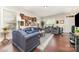 Comfortable living room featuring hardwood floors, ample seating, and plenty of natural light at 9807 Maywine Cir, Huntersville, NC 28078