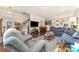 Bright, open living room featuring a staircase, modern furniture, and hardwood floors at 9807 Maywine Cir, Huntersville, NC 28078
