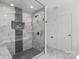 Contemporary tiled shower with glass door, sleek fixtures, and built-in niche at 9830 Spring Harvest Dr, Mint Hill, NC 28227
