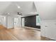 Large bedroom with wood floors, ceiling fan, and doors leading to bath area at 9830 Spring Harvest Dr, Mint Hill, NC 28227