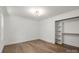 Spacious bedroom showcasing hardwood floors and a closet with open shelving for ample storage at 9830 Spring Harvest Dr, Mint Hill, NC 28227