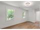 Bright bedroom with hardwood floors and two windows offering pleasant natural light and outdoor views at 9830 Spring Harvest Dr, Mint Hill, NC 28227