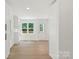 Hallway view showing the bright white paint, natural light, white trim and wood floors at 9830 Spring Harvest Dr, Mint Hill, NC 28227