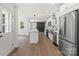 Beautiful open kitchen with stainless steel appliances and white cabinets with island at 9830 Spring Harvest Dr, Mint Hill, NC 28227
