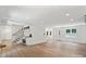 Open-concept living area with beautiful hardwood floors and built-in storage at 9830 Spring Harvest Dr, Mint Hill, NC 28227