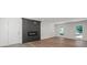 Modern living room featuring hardwood floors, a black fireplace and access to outdoors at 9830 Spring Harvest Dr, Mint Hill, NC 28227