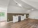 Stylish living space with hardwood floors, a wet bar, and modern cabinetry at 9830 Spring Harvest Dr, Mint Hill, NC 28227
