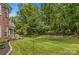 Well-manicured backyard with a black metal fence and brick house in background at 1011 Wadsworth Ln, Indian Trail, NC 28079