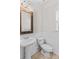 Powder room featuring pedestal sink, toilet, and decorative framed mirror at 1011 Wadsworth Ln, Indian Trail, NC 28079