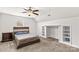 This carpeted bedroom features a custom closet and a wooden headboard with an adjacent nightstand at 1011 Wadsworth Ln, Indian Trail, NC 28079