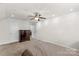 A spacious bedroom with carpet flooring, a dresser, white walls, and a ceiling fan at 1011 Wadsworth Ln, Indian Trail, NC 28079