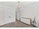 Bedroom with white trim, neutral walls, and a bright chandelier at 1011 Wadsworth Ln, Indian Trail, NC 28079