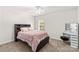 Cozy bedroom with a black wooden bed, ceiling fan, and vanity at 1011 Wadsworth Ln, Indian Trail, NC 28079