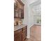 Butler's pantry with granite countertops, wood cabinets, and view into dining room at 1011 Wadsworth Ln, Indian Trail, NC 28079