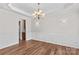 Elegant dining room featuring hardwood floors, wainscoting, trey ceiling, and chandelier at 1011 Wadsworth Ln, Indian Trail, NC 28079