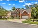 Charming two-story brick home with well-manicured lawn, mature trees and attached two-car garage in desirable neighborhood at 1011 Wadsworth Ln, Indian Trail, NC 28079