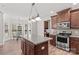 Kitchen features wood floors, granite countertops, island and stainless steel appliances at 1011 Wadsworth Ln, Indian Trail, NC 28079