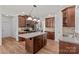 Bright kitchen features wood floors, brown cabinets, granite countertops and stainless steel appliances at 1011 Wadsworth Ln, Indian Trail, NC 28079