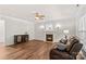 Living room features wood floors, fireplace, ceiling fan, and large windows at 1011 Wadsworth Ln, Indian Trail, NC 28079