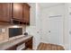 Home office with built-in desk, cabinets, and wood floors at 1011 Wadsworth Ln, Indian Trail, NC 28079