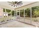 Screened patio with ceiling fan, white railings, and a concrete floor overlooking a fenced backyard at 1011 Wadsworth Ln, Indian Trail, NC 28079