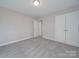 This bright bedroom features fresh neutral paint and carpet, and a double closet at 1016 Forest Dr, Marshville, NC 28103