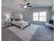 A bright bedroom is decorated with an area rug, bench and painting at 1016 Forest Dr, Marshville, NC 28103