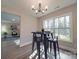 Modern dining area with a sleek table and chairs, and a view to the living area at 1016 Forest Dr, Marshville, NC 28103