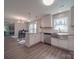 Bright kitchen with white cabinets, stainless steel sink, and modern bar seating at 1016 Forest Dr, Marshville, NC 28103