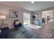 Well-lit living room with access to the outdoors and a view of the kitchen at 1016 Forest Dr, Marshville, NC 28103