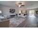Bright living room featuring neutral walls, modern furnishings, and a ceiling fan at 1016 Forest Dr, Marshville, NC 28103