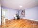 Empty bedroom with hardwood floors, lilac walls, one window, and a utility ladder at 1036 11Th Street Circle Nw Dr, Hickory, NC 28601