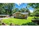 Brick home with mature trees, green lawn and charming covered porch at 1036 11Th Street Circle Nw Dr, Hickory, NC 28601
