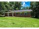 Single-story brick home featuring a manicured lawn and inviting front porch at 1036 11Th Street Circle Nw Dr, Hickory, NC 28601