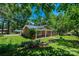 Beautifully landscaped brick home with lush green lawn, flowering plants, and mature shade trees at 1036 11Th Street Circle Nw Dr, Hickory, NC 28601