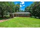 Attractive brick home with a manicured lawn, covered entry, and mature trees at 1036 11Th Street Circle Nw Dr, Hickory, NC 28601