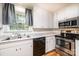 Modern kitchen with stainless steel appliances, black dishwasher, and white cabinetry at 1036 11Th Street Circle Nw Dr, Hickory, NC 28601