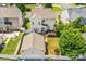 An aerial view of a two-story home with a spacious backyard, detached garage, and a wooden deck at 10509 Serape Rd, Charlotte, NC 28277