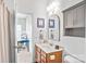 Bathroom featuring vanity and mirror with an open door to a secondary room/office at 10509 Serape Rd, Charlotte, NC 28277