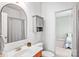 Bathroom featuring vanity and mirror with an open door to a secondary bedroom at 10509 Serape Rd, Charlotte, NC 28277