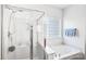 Bathroom showcasing a glass shower, soaking tub, and a privacy glass block window at 10509 Serape Rd, Charlotte, NC 28277