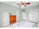 Bedroom with neutral walls, ceiling fan, windows and doors leading to other areas at 10509 Serape Rd, Charlotte, NC 28277