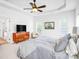 Bright bedroom features a ceiling fan, white walls, neutral carpet, and stylish striped bedding set at 10509 Serape Rd, Charlotte, NC 28277