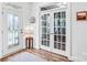 Bright entryway with beautiful wood floors, stylish decor, and glass panel doors at 10509 Serape Rd, Charlotte, NC 28277