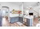 Kitchen boasts gray cabinets, stainless steel appliances, open shelving, and quartz countertops at 10509 Serape Rd, Charlotte, NC 28277