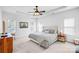 Serene main bedroom features a tray ceiling, a ceiling fan, neutral tones, and ample natural light at 10509 Serape Rd, Charlotte, NC 28277